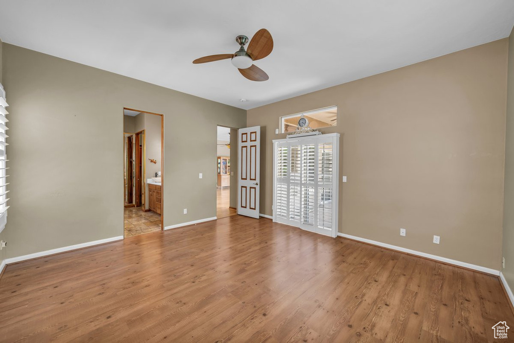 Spare room with a ceiling fan and light wood-style floors