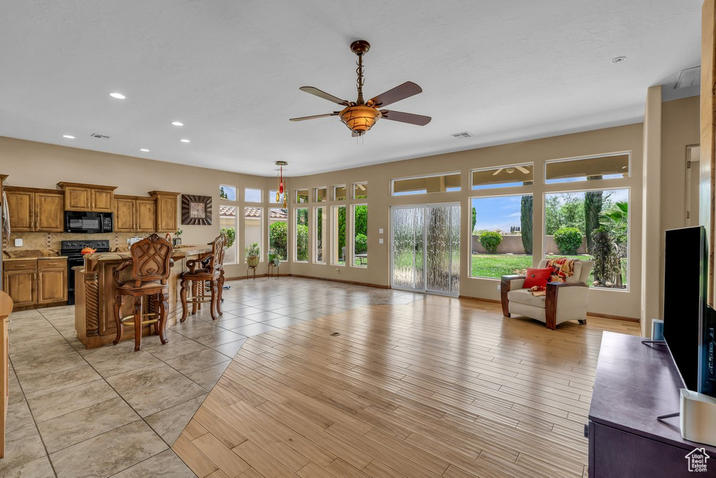 Living area with ceiling fan and recessed lighting
