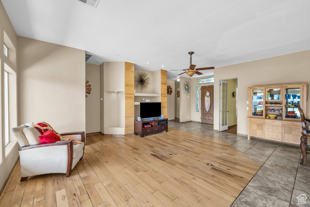 Living area with a ceiling fan, wood finished floors, and recessed lighting