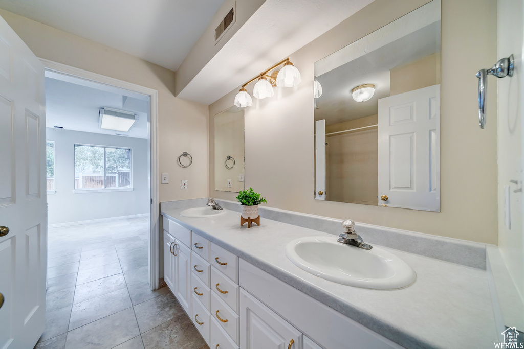 Full bathroom featuring double vanity and tile patterned floors