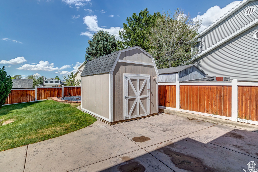 View of shed featuring a fenced backyard
