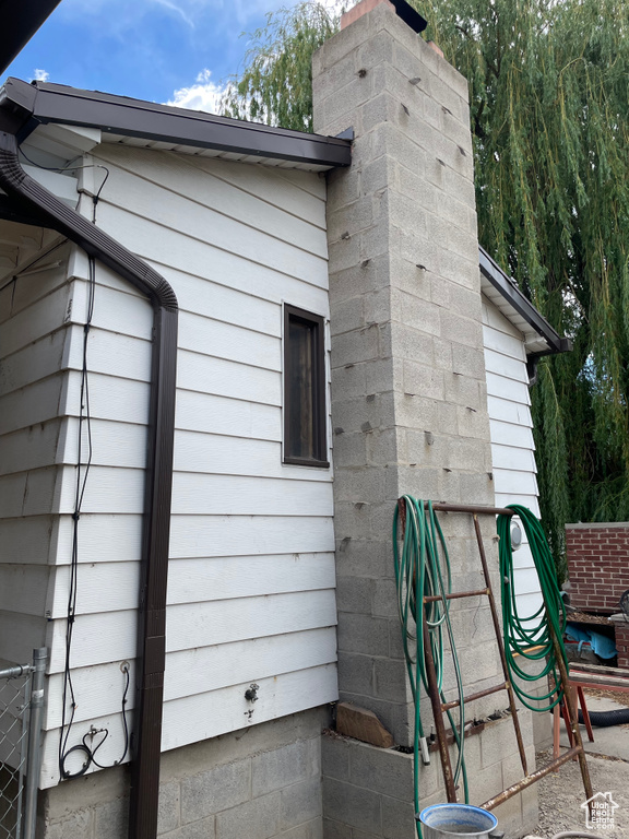 View of property exterior featuring a chimney