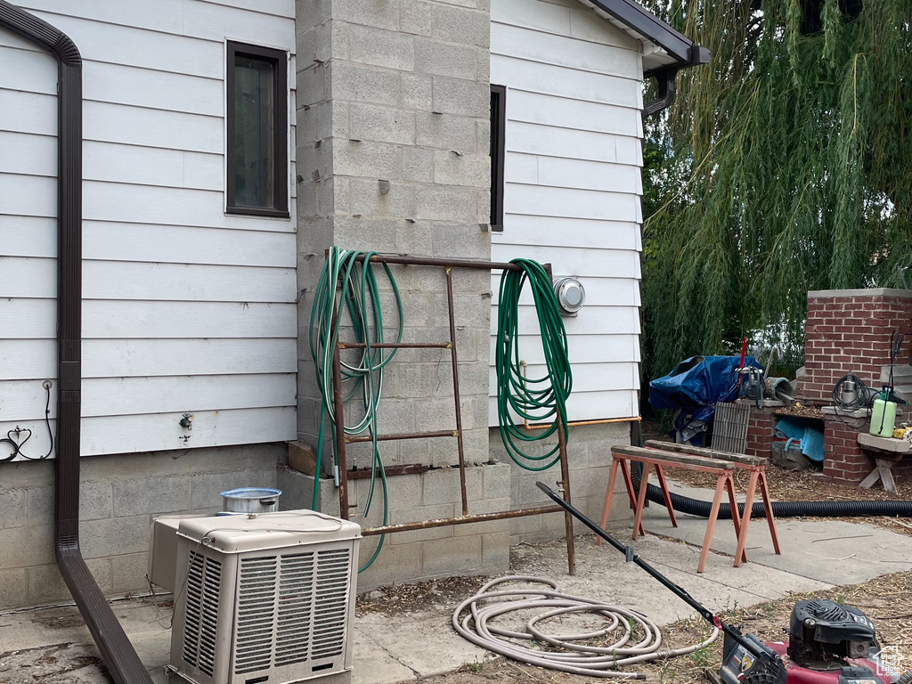 Back of house with a chimney and a patio area