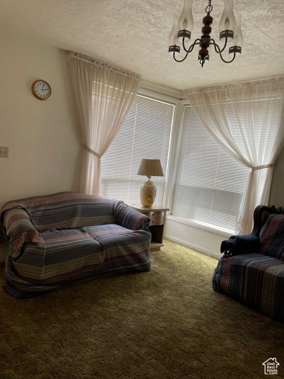 Living room featuring a chandelier and carpet