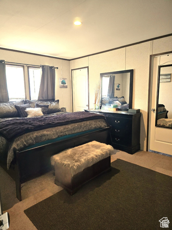 Bedroom with carpet flooring, crown molding, and recessed lighting
