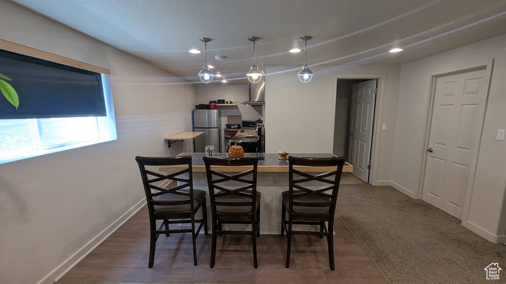 Dining space with recessed lighting and baseboards