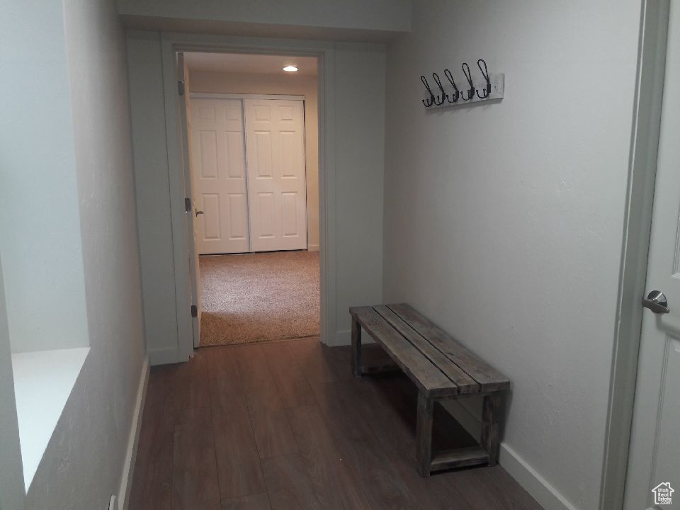 Corridor featuring wood finished floors and baseboards