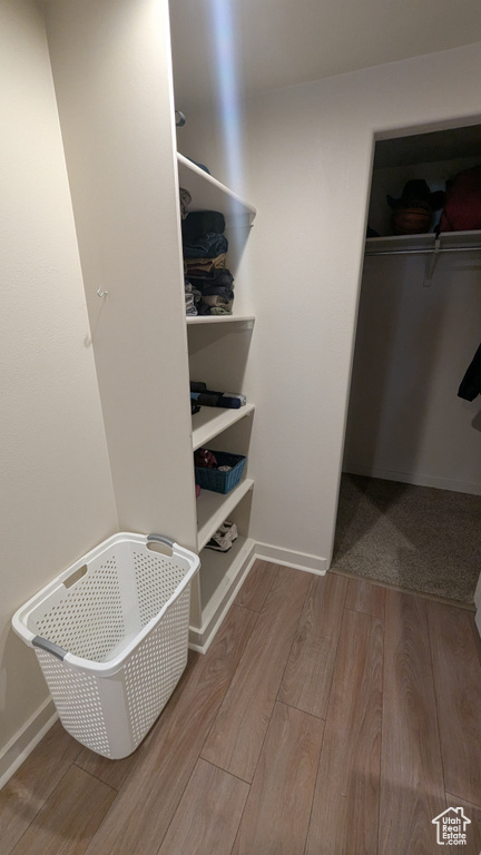 Spacious closet featuring wood finished floors