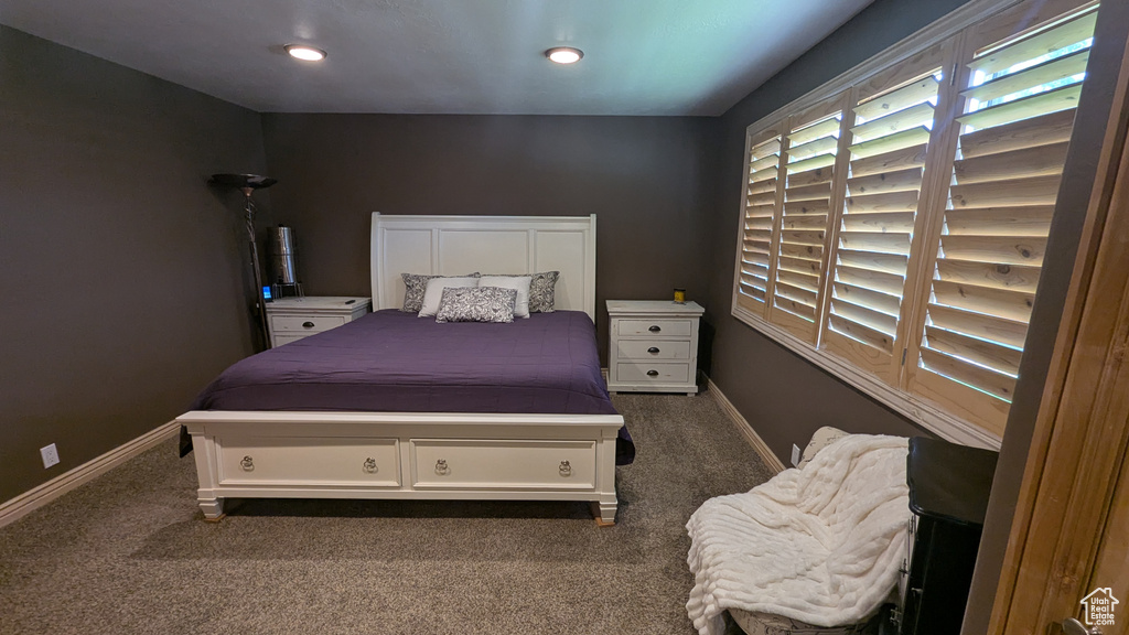 Bedroom with dark colored carpet and recessed lighting