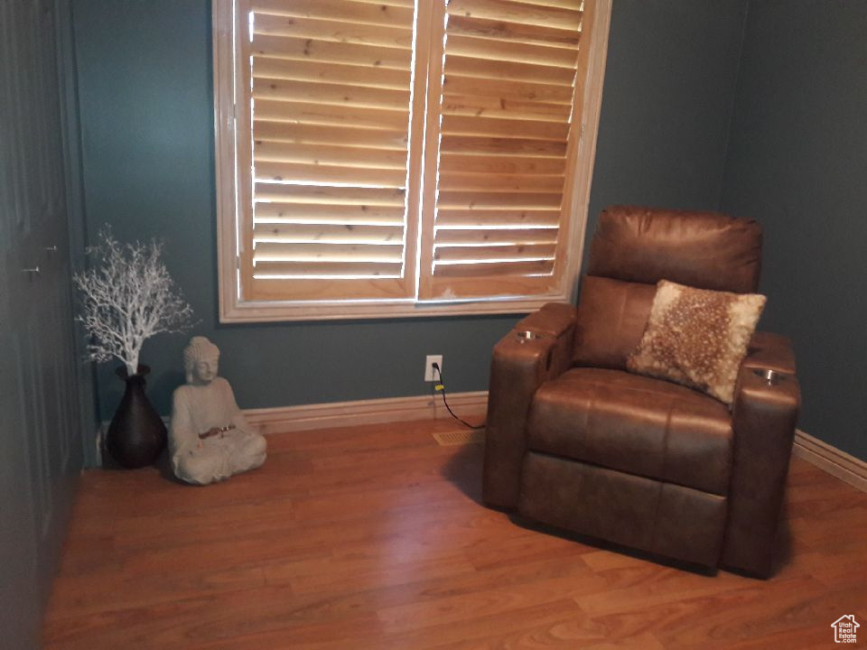Sitting room featuring baseboards and wood finished floors