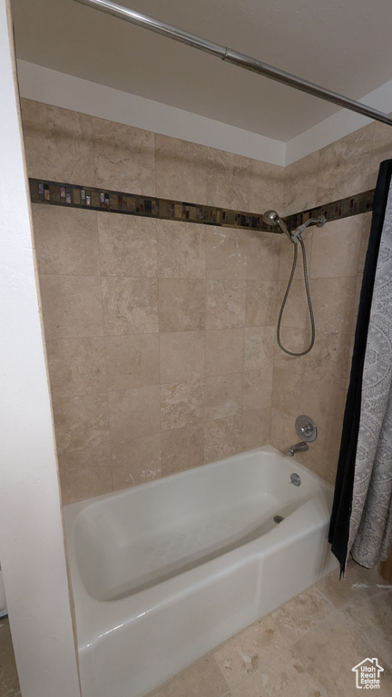 Bathroom featuring shower / tub combo with curtain