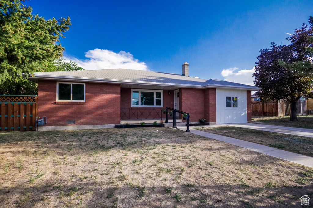 Single story home with brick siding and a chimney