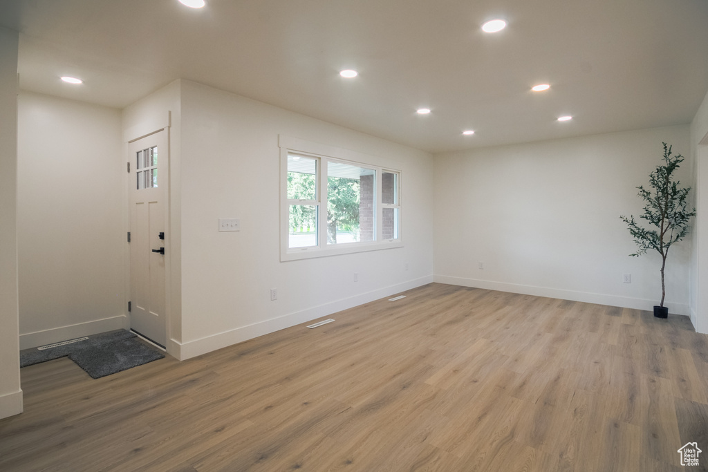 Spare room with wood finished floors and recessed lighting