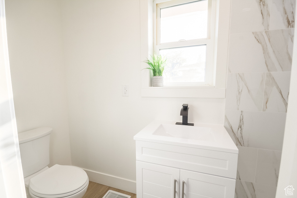 Bathroom featuring vanity and wood finished floors