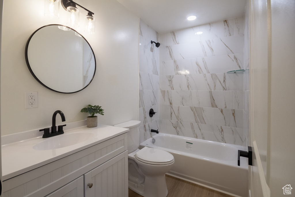 Full bathroom featuring vanity, bathtub / shower combination, and wood finished floors