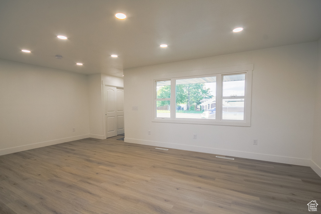 Unfurnished room featuring wood finished floors and recessed lighting