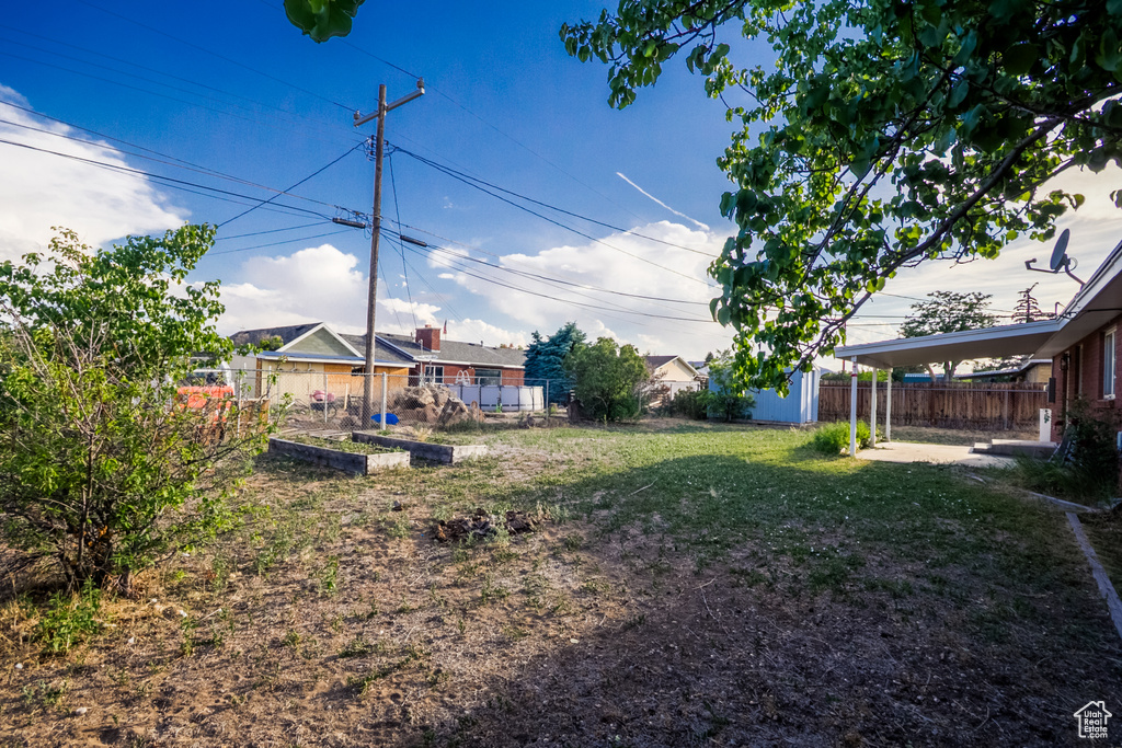 View of yard with a vegetable garden and an outbuilding