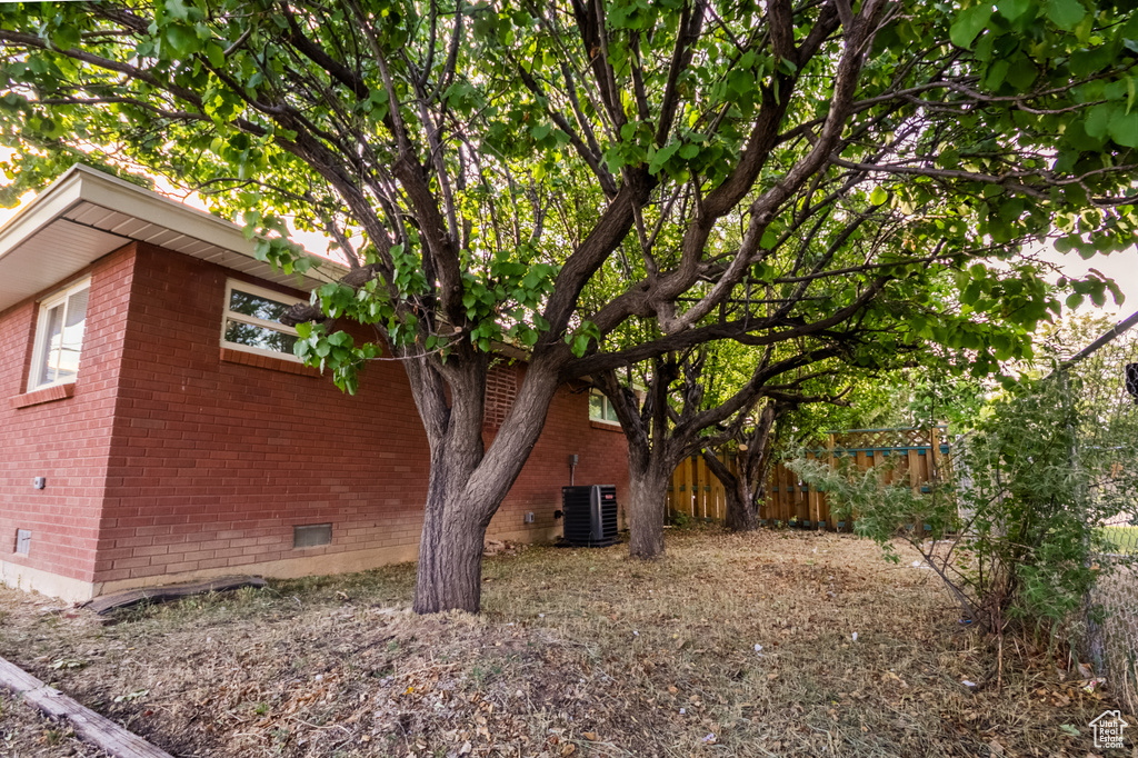 View of side of property featuring brick siding and crawl space