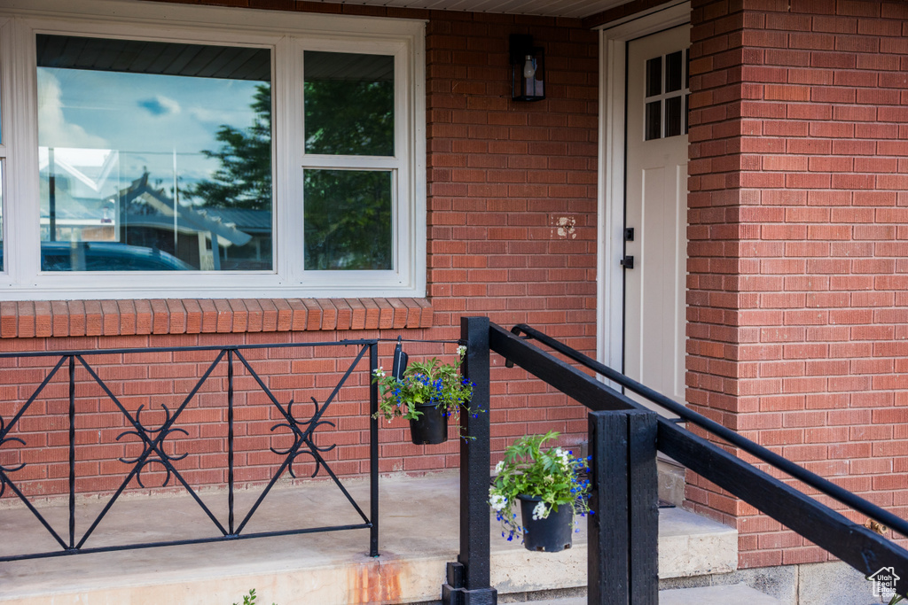 Property entrance featuring brick siding