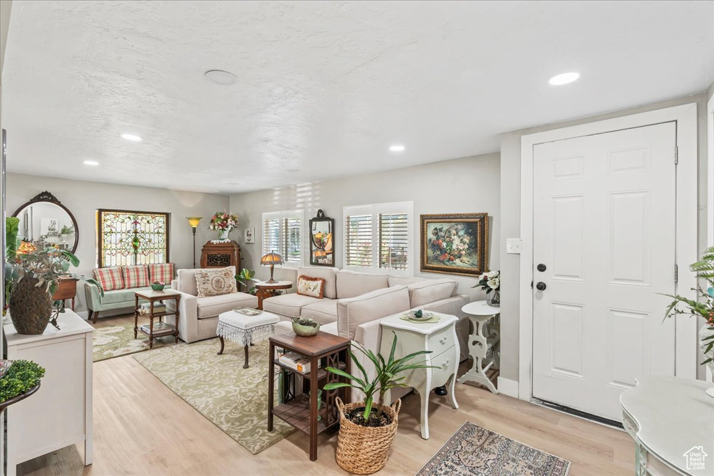 Living room featuring light wood-style flooring and recessed lighting