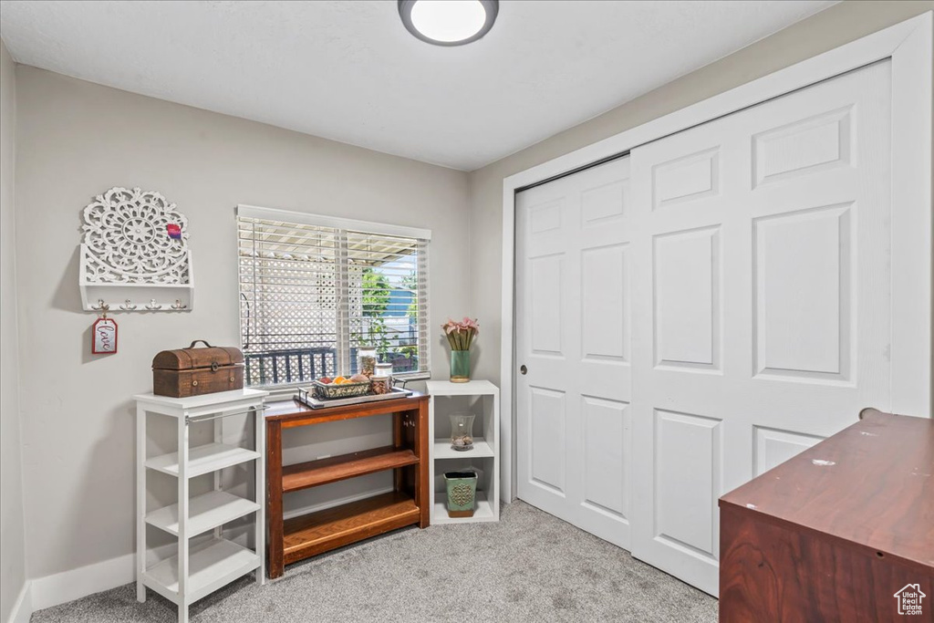 Office space with light colored carpet and baseboards