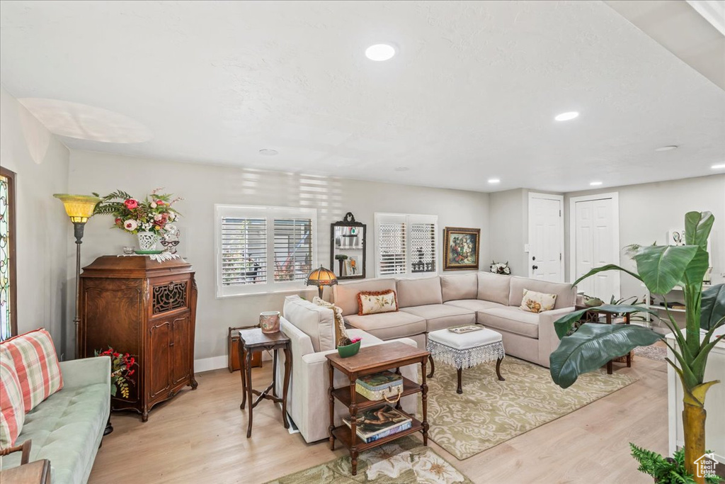Living area featuring light wood-type flooring and recessed lighting