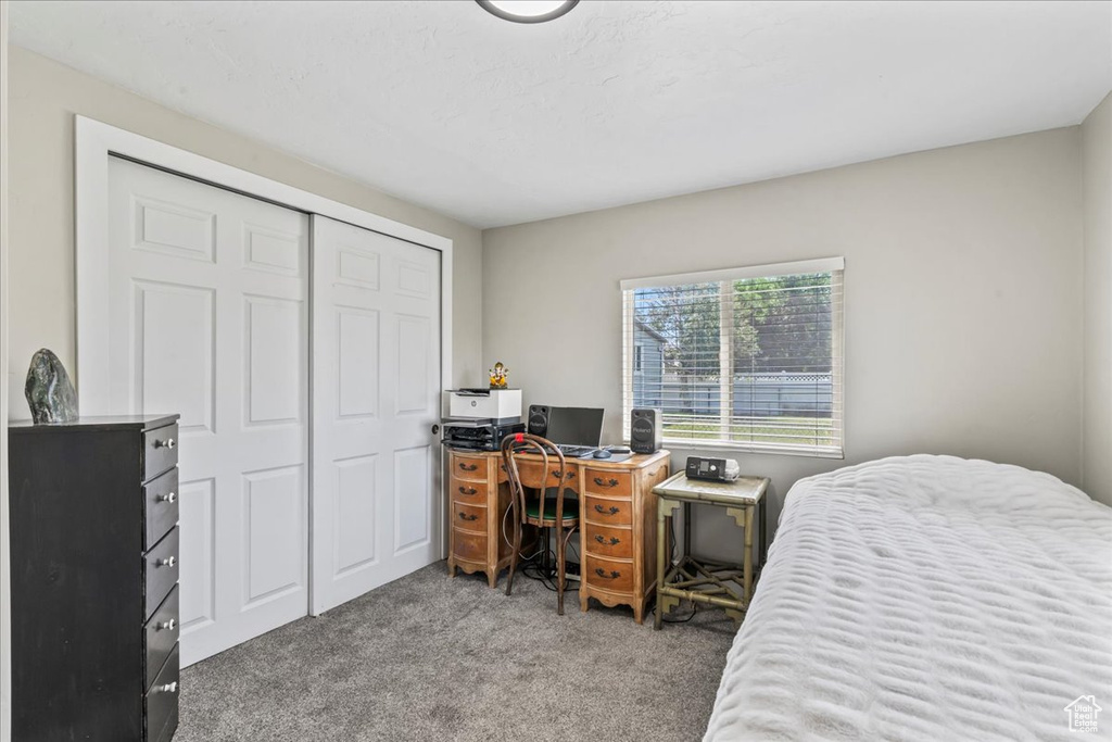 Bedroom with carpet flooring, a closet, and a desk