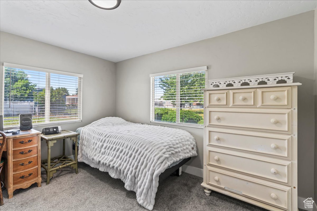 Bedroom featuring light carpet