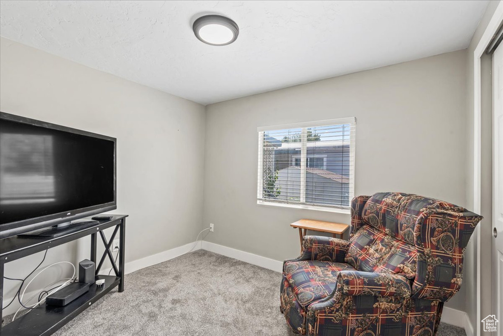 Sitting room with carpet flooring and baseboards