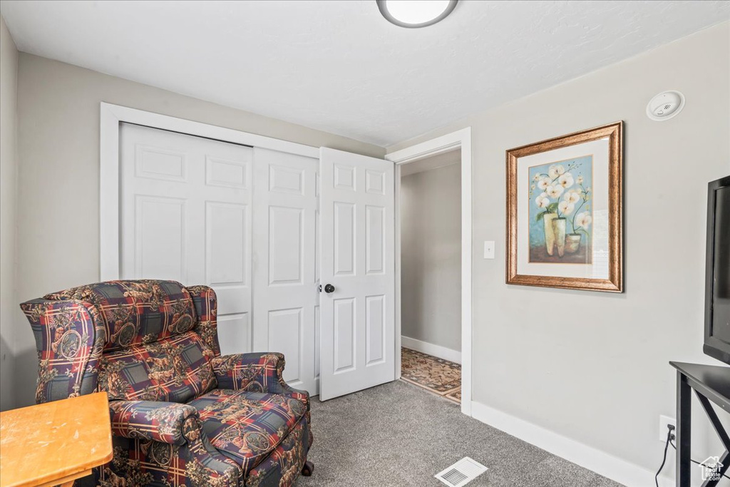 Living area with carpet floors and baseboards