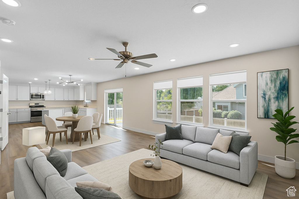 Living area featuring recessed lighting, a ceiling fan, and light wood-style floors