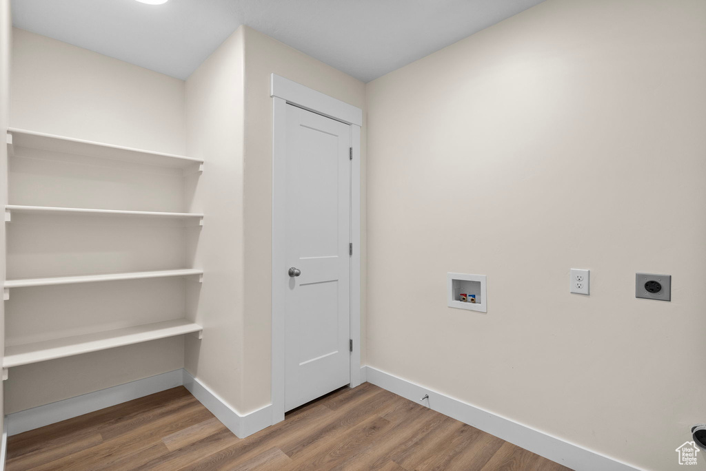 Laundry room with wood finished floors, electric dryer hookup, and hookup for a washing machine