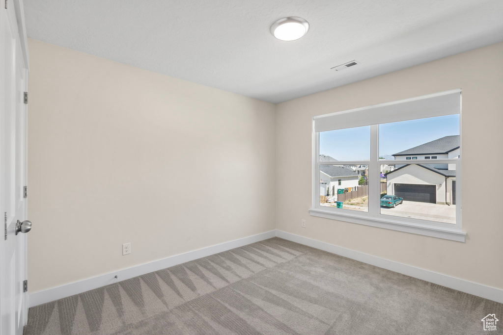 Spare room with baseboards and carpet flooring