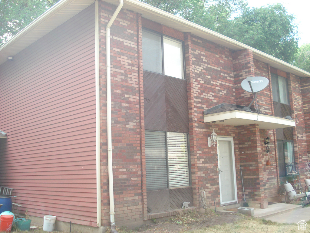 View of front of home featuring brick siding