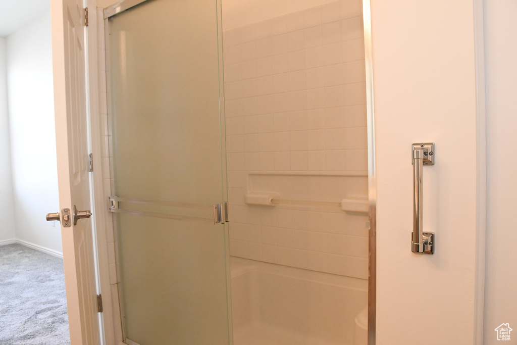 Bathroom featuring an enclosed shower and baseboards
