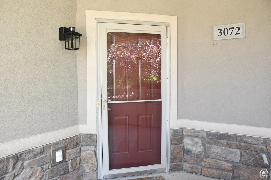 Property entrance with stucco siding and stone siding