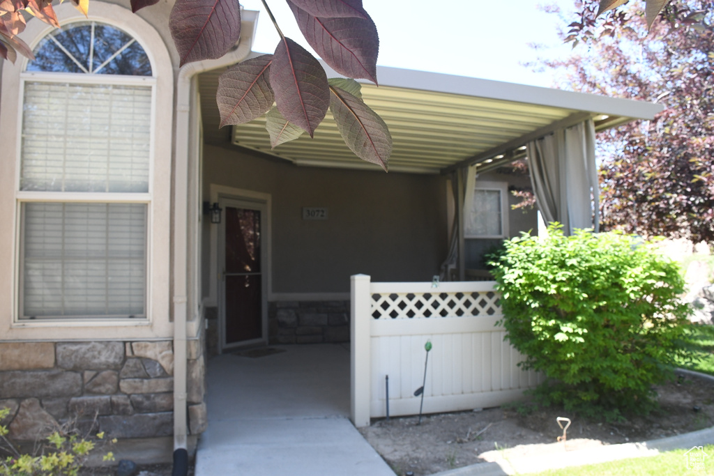 Entrance to property with stone siding