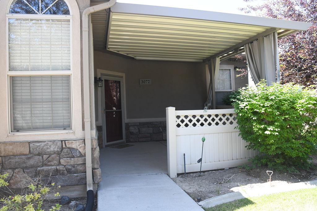Doorway to property featuring stone siding