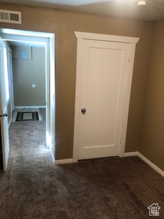 Hallway featuring carpet