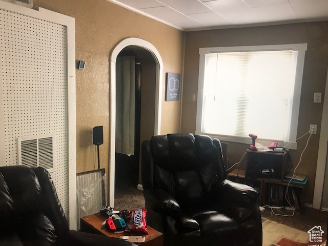 Living area featuring arched walkways and a textured wall