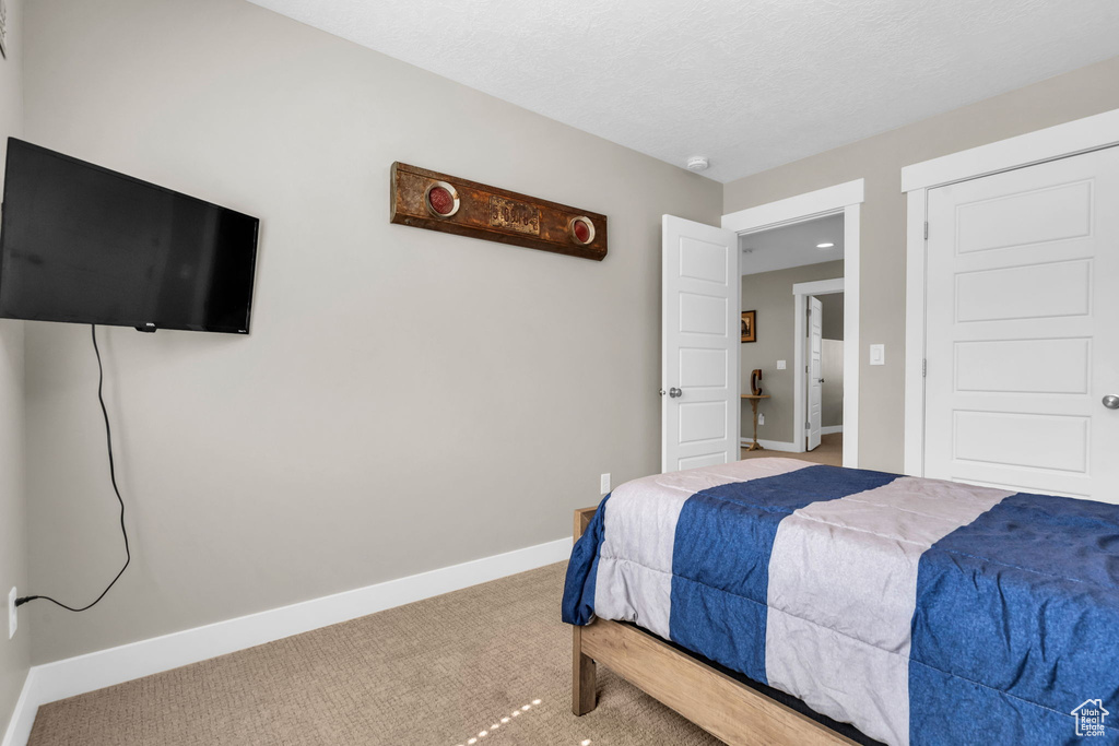 Bedroom with carpet and baseboards