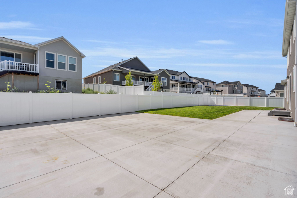 Fenced backyard featuring a residential view and a patio area