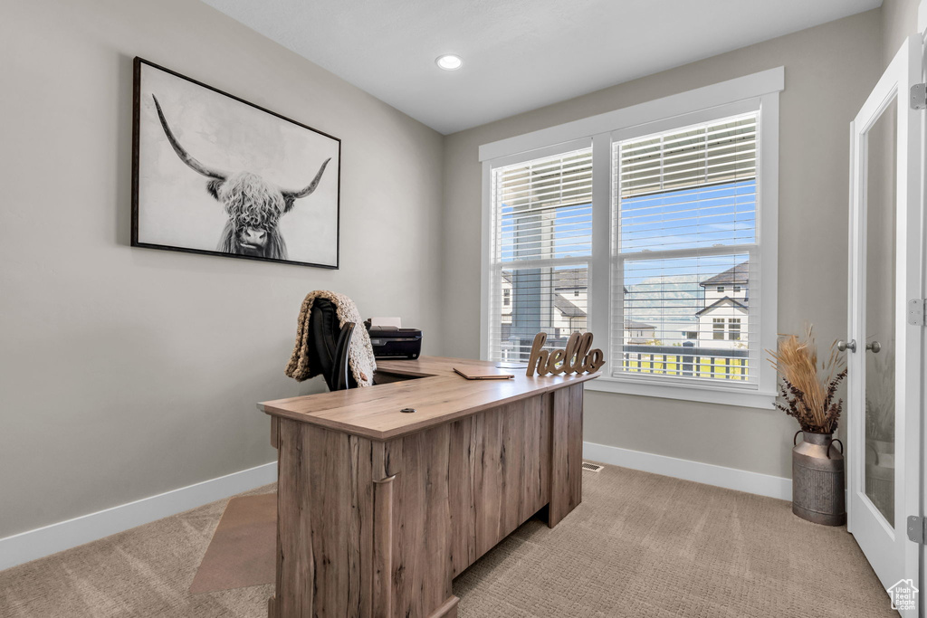 Home office with light carpet and recessed lighting