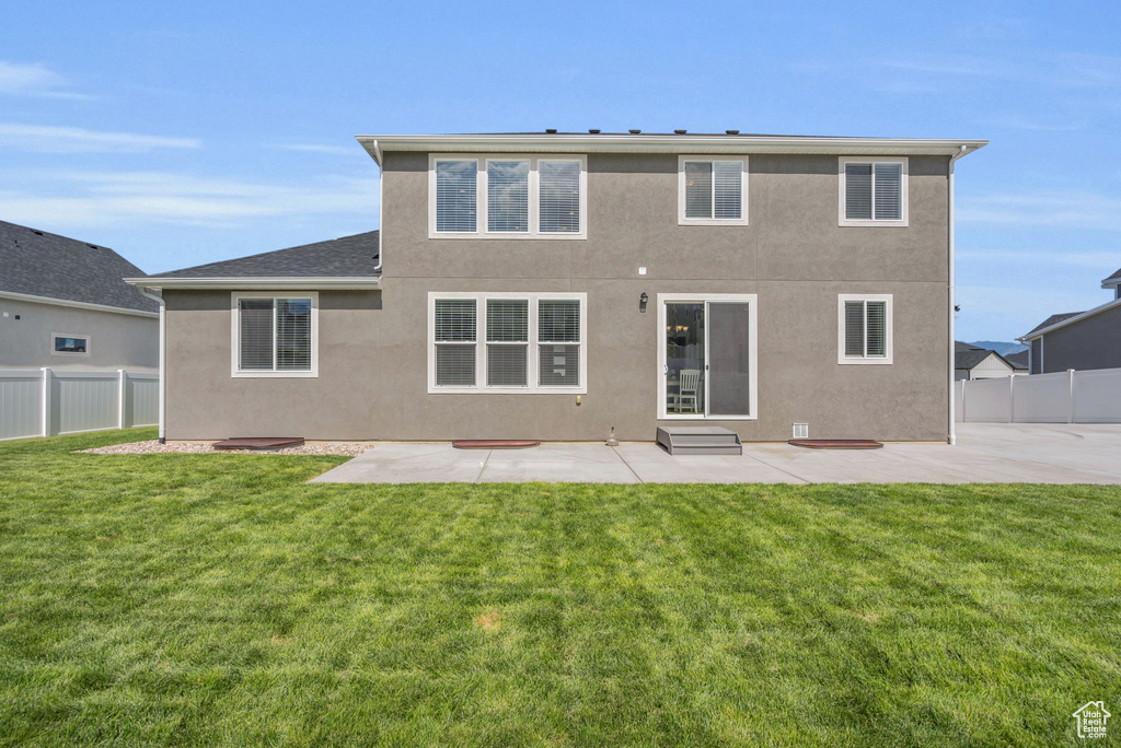 Back of property featuring a patio area, stucco siding, and entry steps
