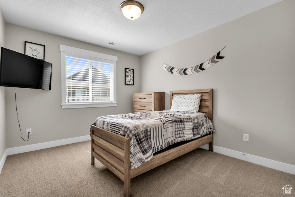 Bedroom featuring baseboards and carpet flooring