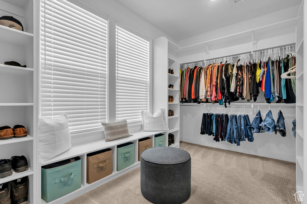 Walk in closet featuring light carpet