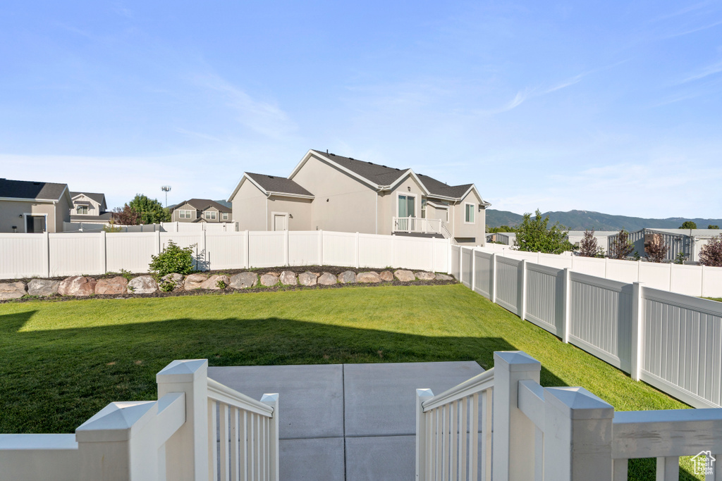 Fenced backyard with a residential view, a patio area, and a mountain view