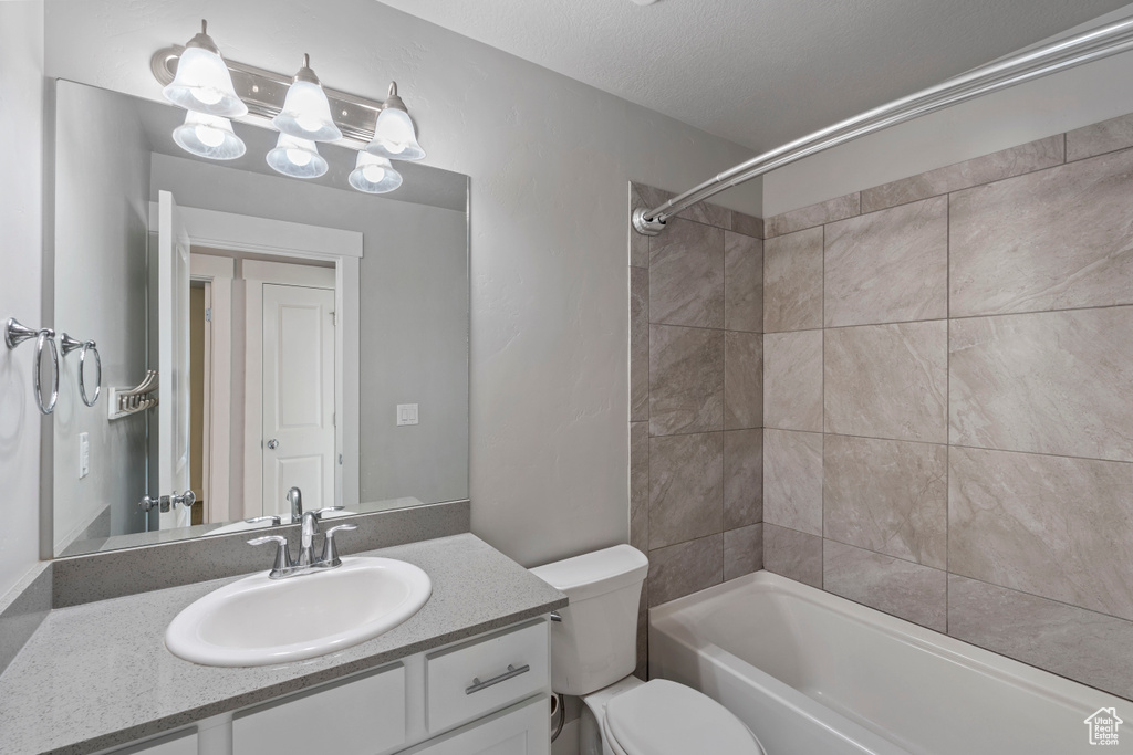 Bathroom with vanity and bathing tub / shower combination