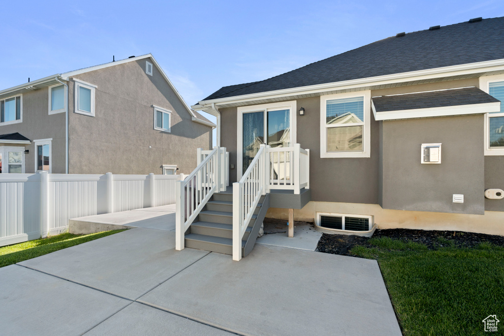 Back of house featuring a patio area and stucco siding