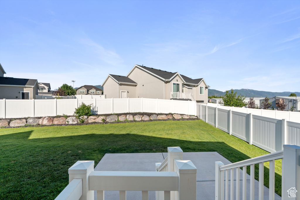 Fenced yard with a residential view and a mountain view